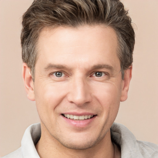 Joyful white adult male with short  brown hair and brown eyes