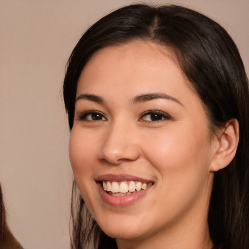 Joyful white young-adult female with long  brown hair and brown eyes