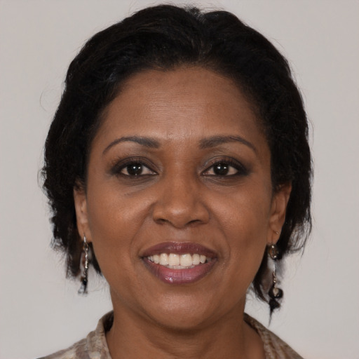 Joyful black adult female with medium  brown hair and brown eyes