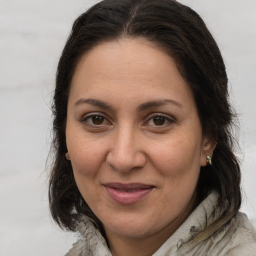Joyful white adult female with medium  brown hair and brown eyes