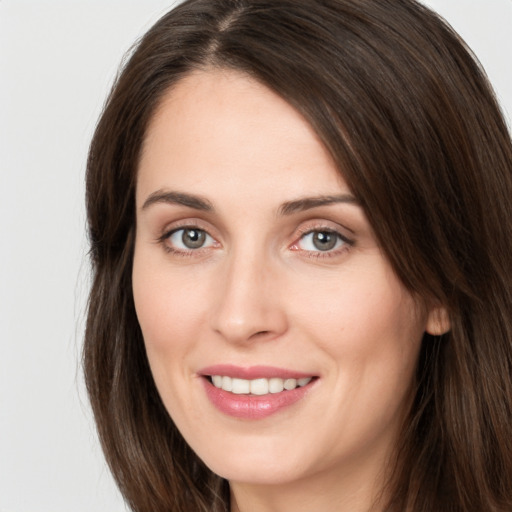 Joyful white young-adult female with long  brown hair and grey eyes