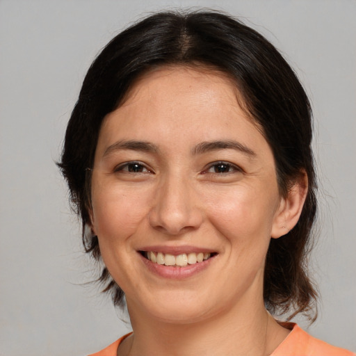 Joyful white adult female with medium  brown hair and brown eyes