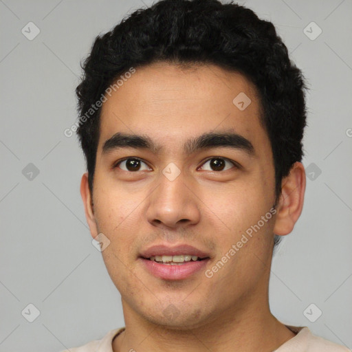 Joyful latino young-adult male with short  black hair and brown eyes