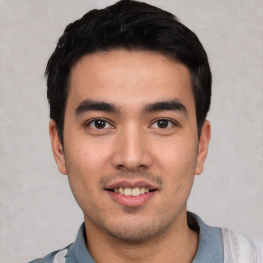 Joyful white young-adult male with short  black hair and brown eyes