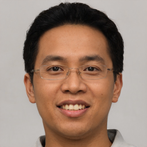 Joyful asian adult male with short  black hair and brown eyes