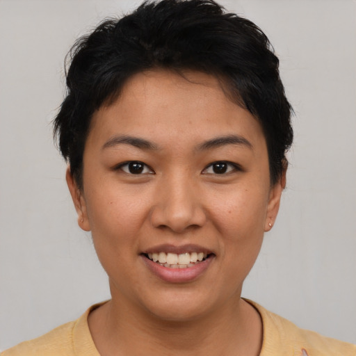 Joyful latino young-adult female with short  brown hair and brown eyes