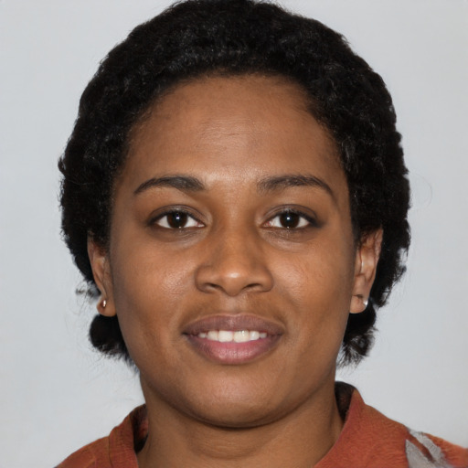 Joyful black young-adult female with medium  black hair and brown eyes