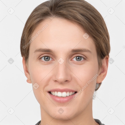 Joyful white young-adult female with short  brown hair and grey eyes