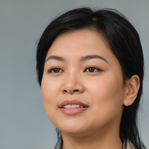 Joyful asian young-adult female with medium  black hair and brown eyes