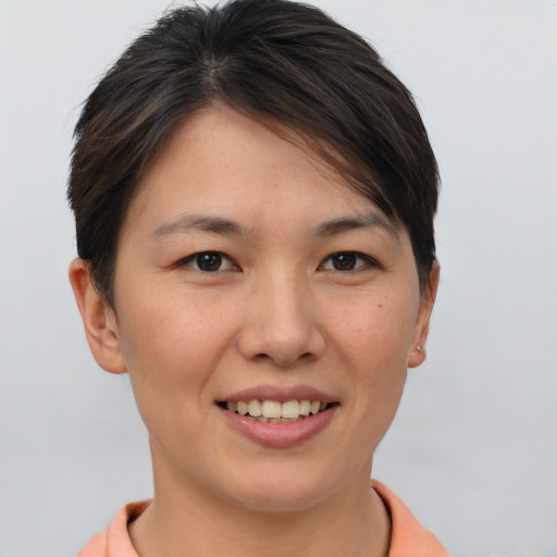 Joyful asian young-adult female with short  brown hair and brown eyes