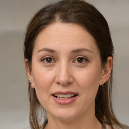 Joyful white adult female with medium  brown hair and brown eyes