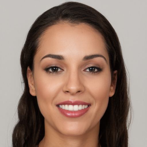 Joyful white young-adult female with long  brown hair and brown eyes