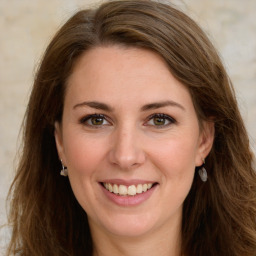 Joyful white young-adult female with long  brown hair and green eyes