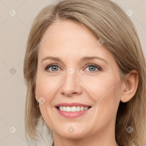 Joyful white adult female with long  brown hair and grey eyes