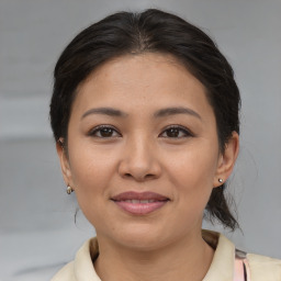 Joyful asian young-adult female with medium  brown hair and brown eyes