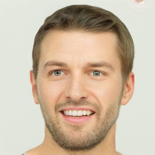 Joyful white young-adult male with short  brown hair and green eyes