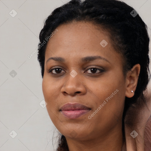 Joyful black adult female with long  black hair and brown eyes