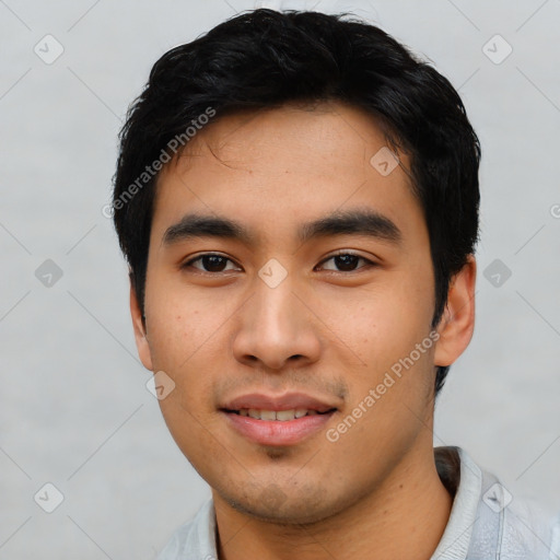 Joyful asian young-adult male with short  black hair and brown eyes