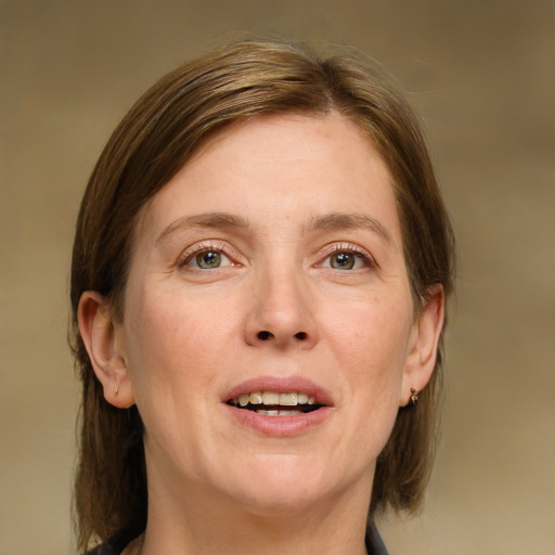 Joyful white adult female with medium  brown hair and blue eyes