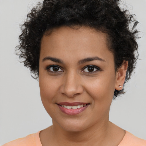 Joyful latino young-adult female with short  brown hair and brown eyes