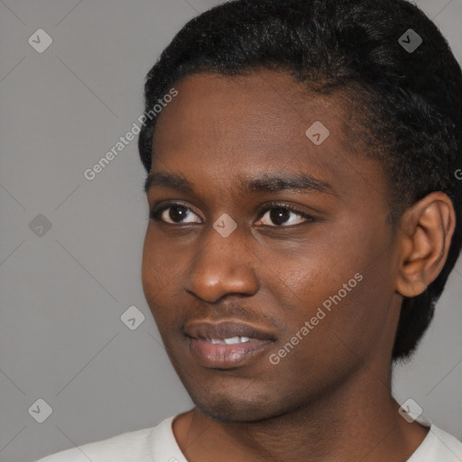 Joyful black young-adult male with short  black hair and brown eyes