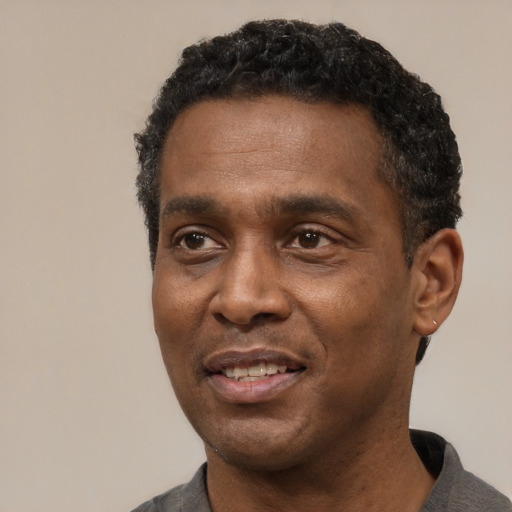 Joyful latino adult male with short  black hair and brown eyes