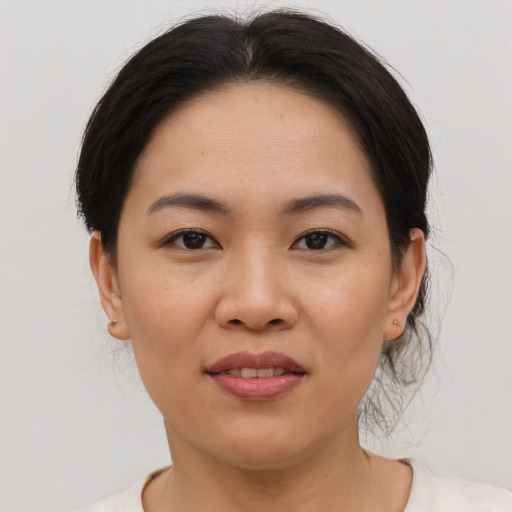 Joyful asian young-adult female with medium  brown hair and brown eyes
