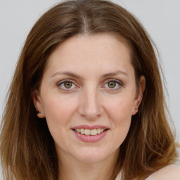 Joyful white young-adult female with long  brown hair and green eyes