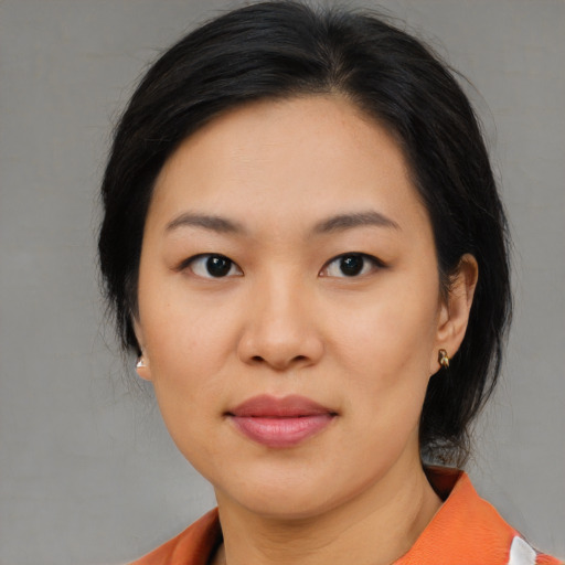 Joyful asian young-adult female with medium  black hair and brown eyes