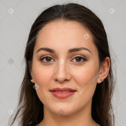 Joyful white young-adult female with long  brown hair and brown eyes