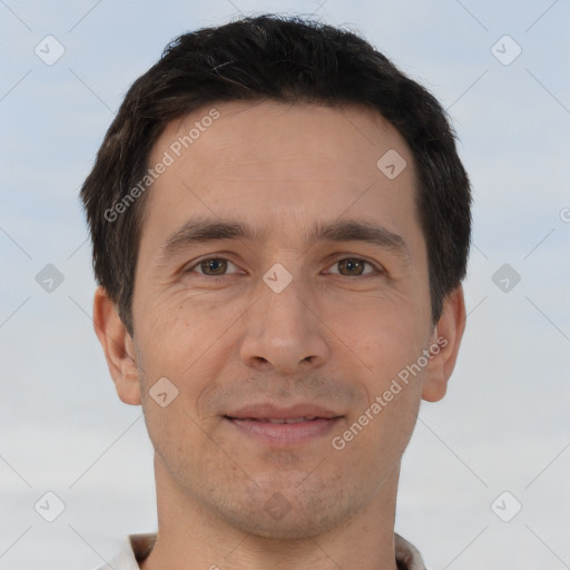 Joyful white adult male with short  brown hair and brown eyes