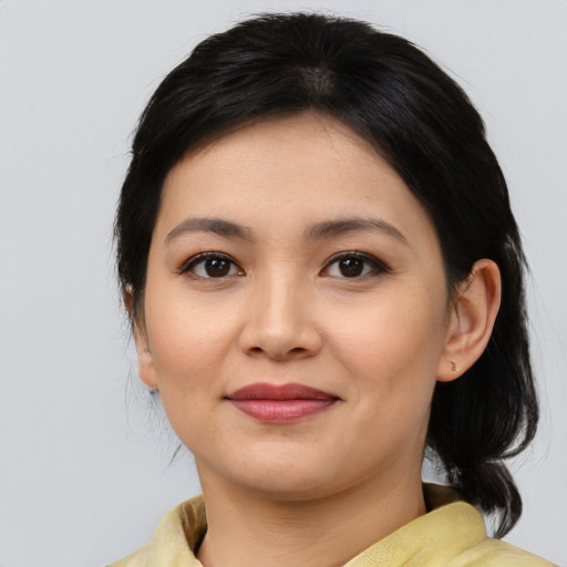 Joyful asian young-adult female with medium  brown hair and brown eyes