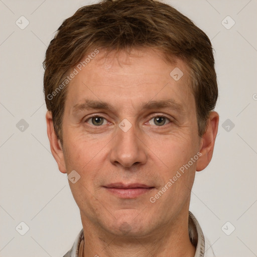 Joyful white adult male with short  brown hair and grey eyes