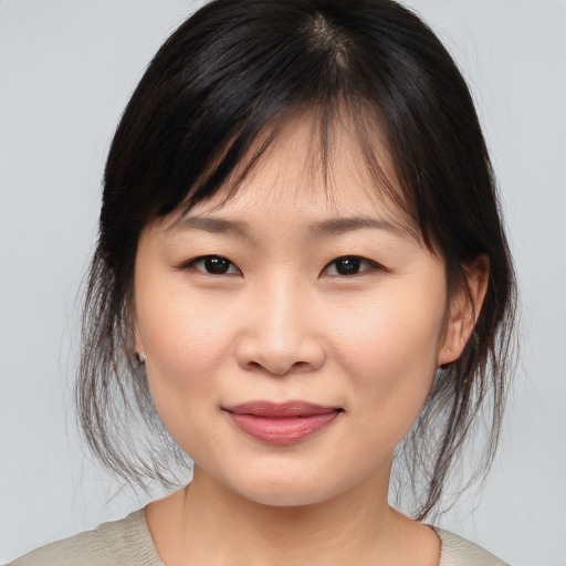 Joyful asian young-adult female with medium  brown hair and brown eyes