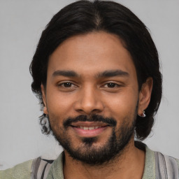 Joyful latino young-adult male with short  black hair and brown eyes