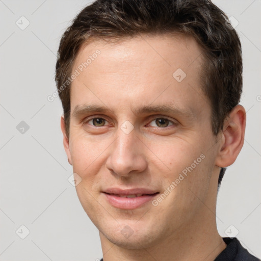 Joyful white young-adult male with short  brown hair and brown eyes