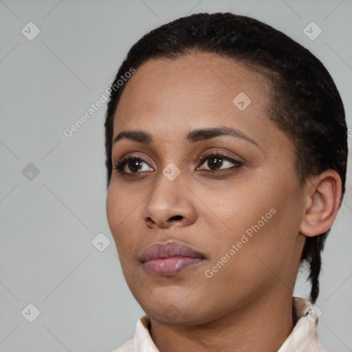 Joyful black young-adult female with short  black hair and brown eyes