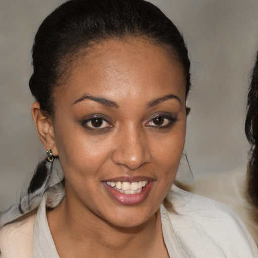 Joyful black young-adult female with medium  brown hair and brown eyes