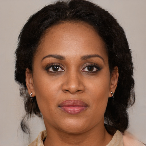 Joyful latino adult female with medium  brown hair and brown eyes