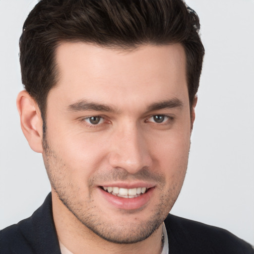 Joyful white young-adult male with short  brown hair and brown eyes