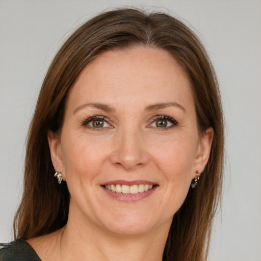 Joyful white adult female with medium  brown hair and blue eyes