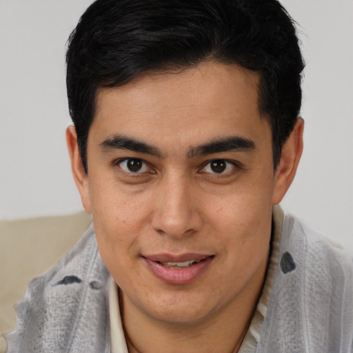 Joyful latino young-adult male with short  brown hair and brown eyes