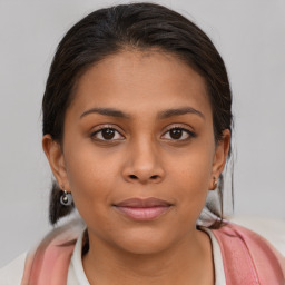 Joyful latino young-adult female with medium  brown hair and brown eyes