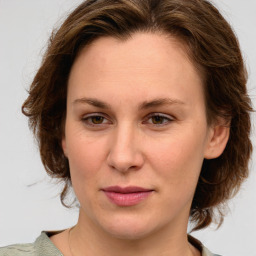 Joyful white young-adult female with medium  brown hair and green eyes