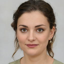 Joyful white young-adult female with medium  brown hair and green eyes