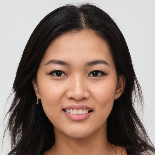 Joyful asian young-adult female with long  black hair and brown eyes