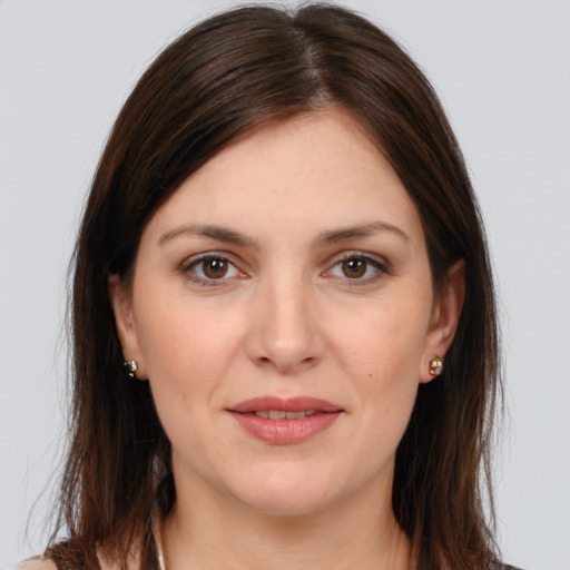 Joyful white young-adult female with long  brown hair and grey eyes