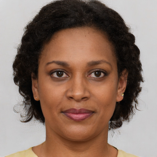 Joyful latino adult female with short  brown hair and brown eyes
