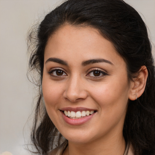 Joyful white young-adult female with long  brown hair and brown eyes