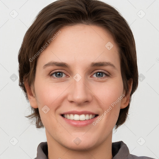 Joyful white young-adult female with short  brown hair and grey eyes